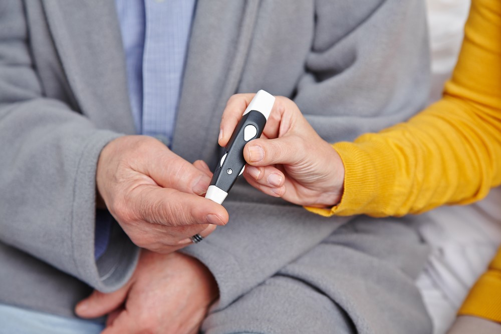 A senior diabetic man and his caregiver, highlighting the idea of being a caregiver for a diabetic patient