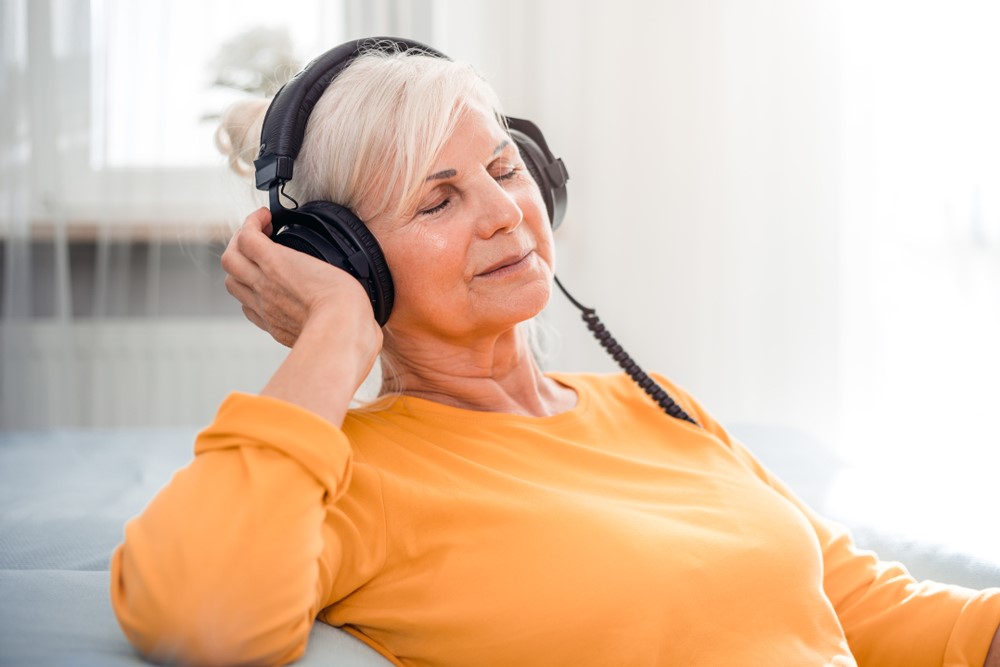 A senior woman listening to music