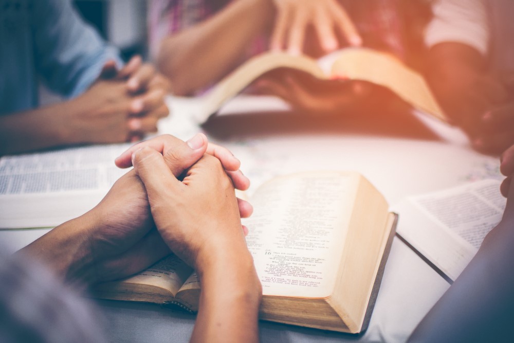 A man with a bible praying