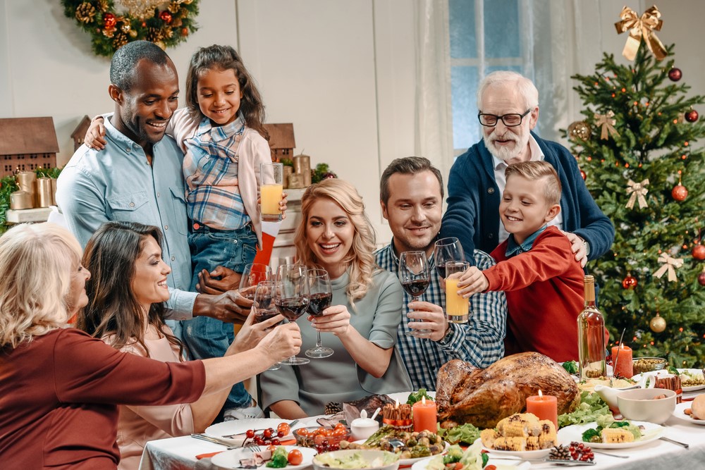 A family celebrating the holidays together, highlighting the idea that caregiver holiday stress doesn't need to be overwhelming.
