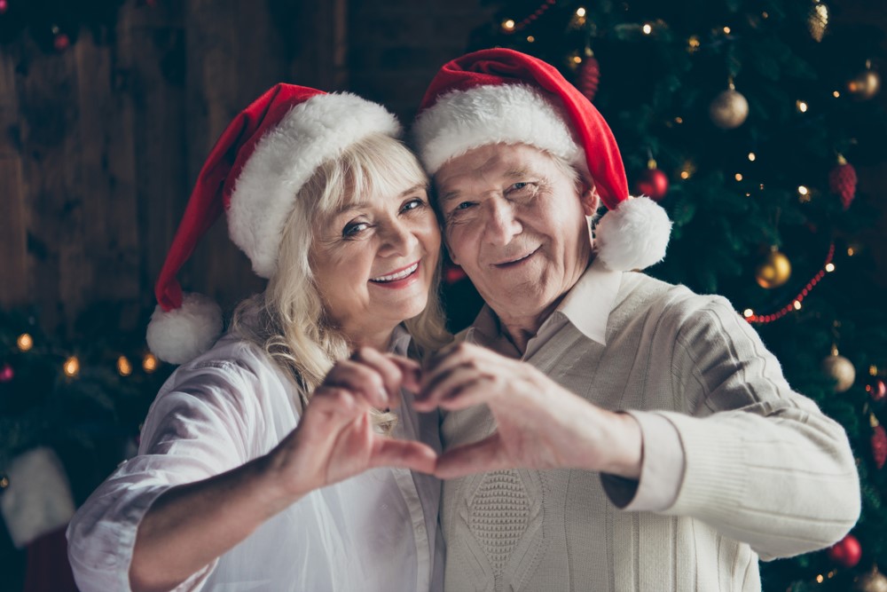 A senior couple being sweet around the holidays