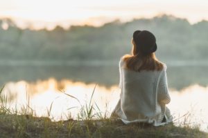 A caregiver practicing mindfulness by the river