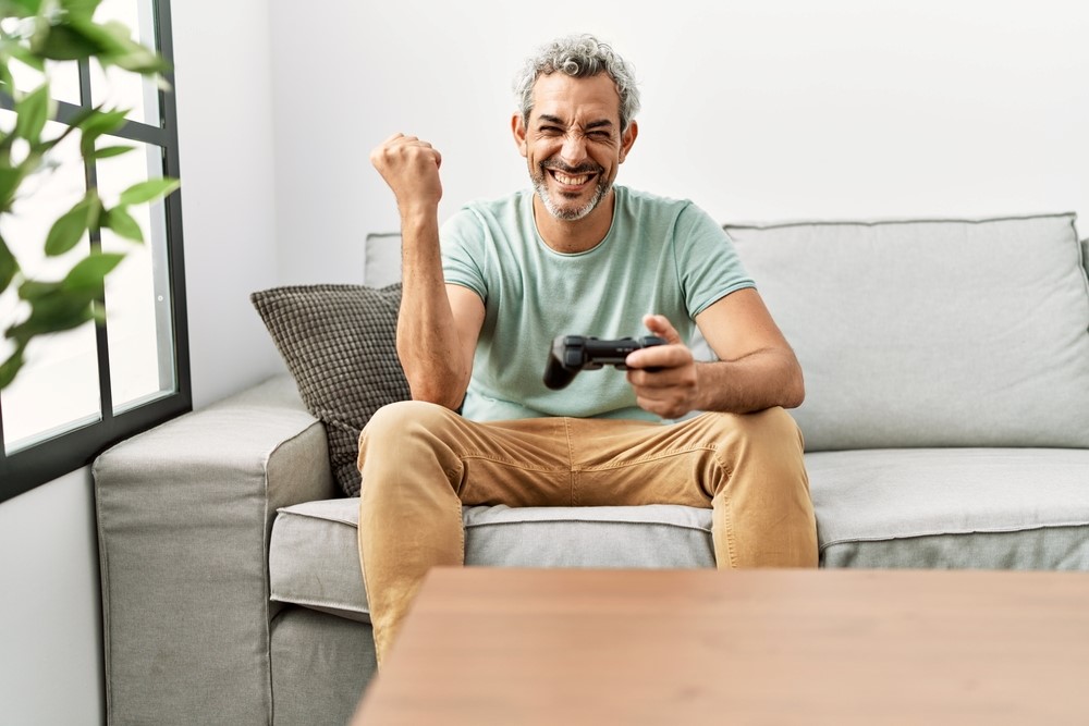 A middle aged man playing a game