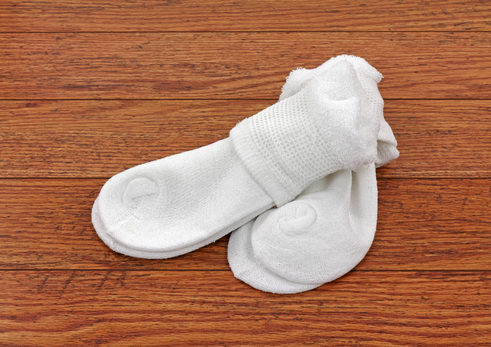 A new pair of Dr. Scholl's diabetic socks on a wooden background