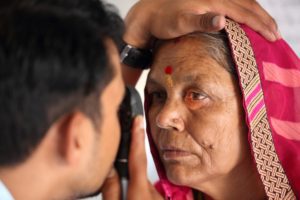 An elderly ethnic senior getting an eye test