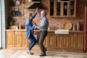 A senior couple dancing in their kitchen, highlighting the benefits of dance for seniors