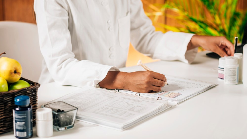 A female integrative medicine doctor writing notes