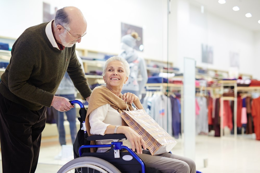 A senior caregiver supporting his wife