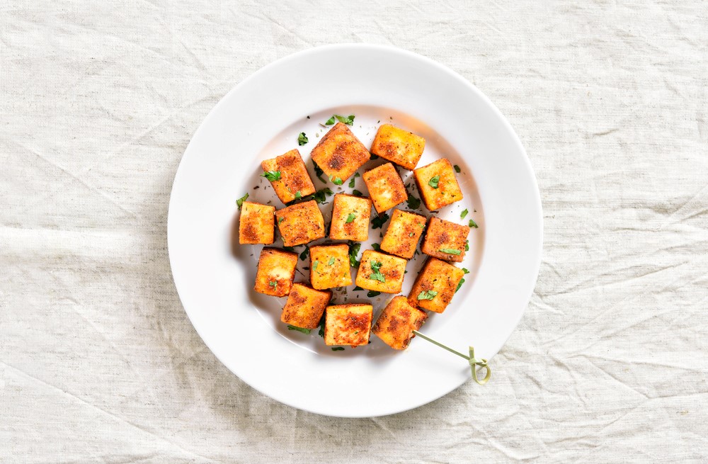 A white plate with roasted paneer