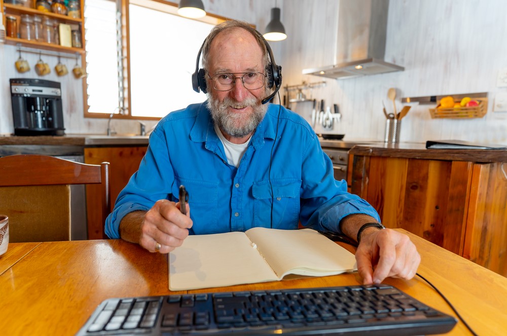 An aging white man using the internet during COVID 19, highlighting the idea of keeping aging parents safe online