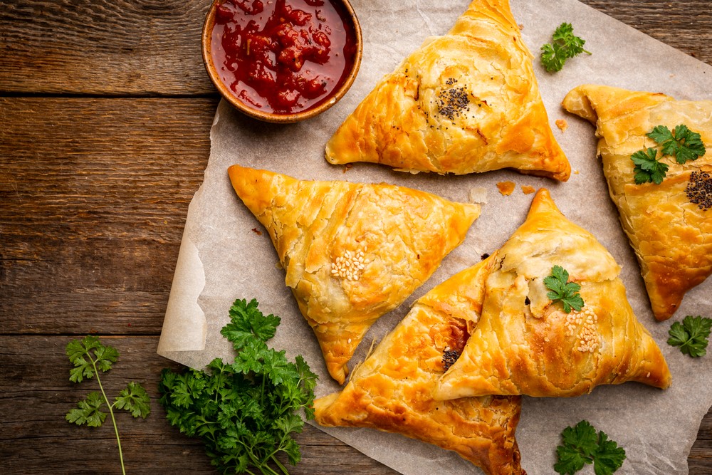 Baked samosas on paper, a type of easy to chew snack for seniors