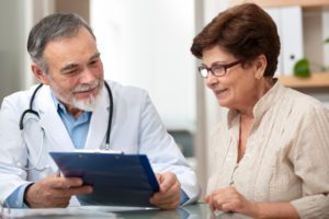 A doctor talking to a female patient as part of a Medicare annual wellness visit