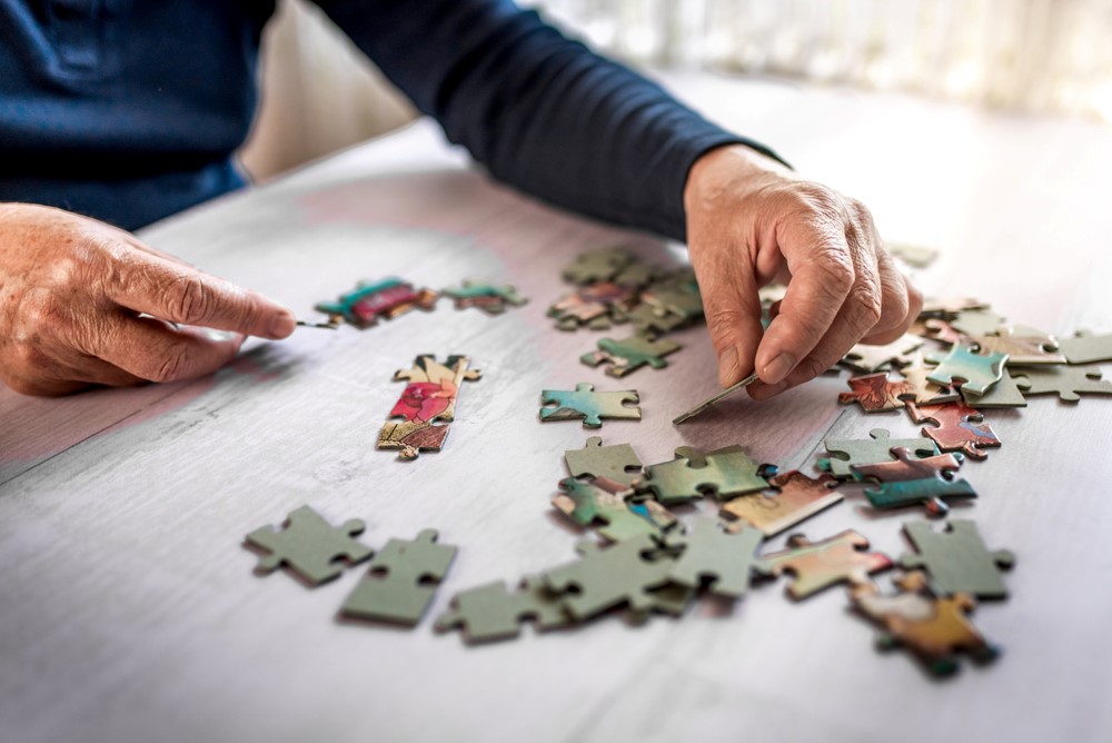 A senior trying to do a puzzle