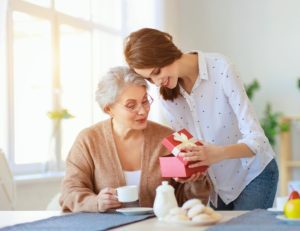 An elderly mother with her daughter, looking at the idea of gifts for elderly parents