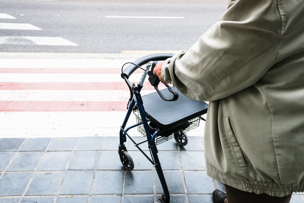 A senior with a walker at a crossing, highlighting the best types of walkers for seniors