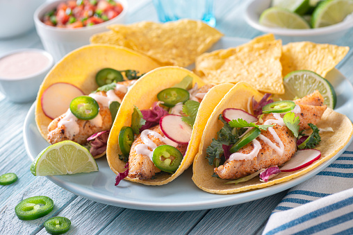 Tacos with radish salad on a light blue plate