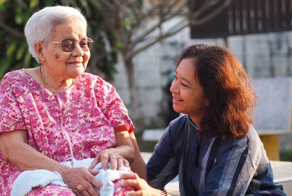 A mother and her daughter, highlighting the idea of being an unpaid adult caregiver