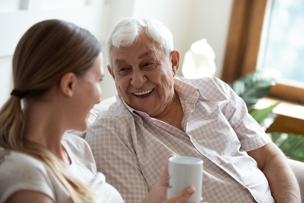 A senior man talking to his granddaughter