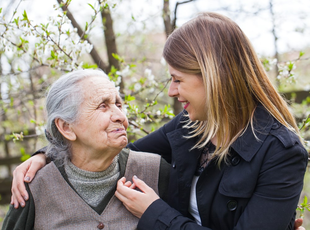 An elderly woman with her granddaughter, highlighting the idea of caring for elderly grandparents