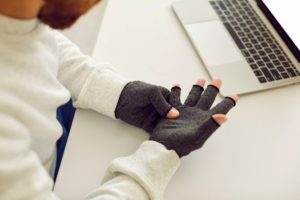 Someone wearing a pair of the best compression gloves for Raynaud's