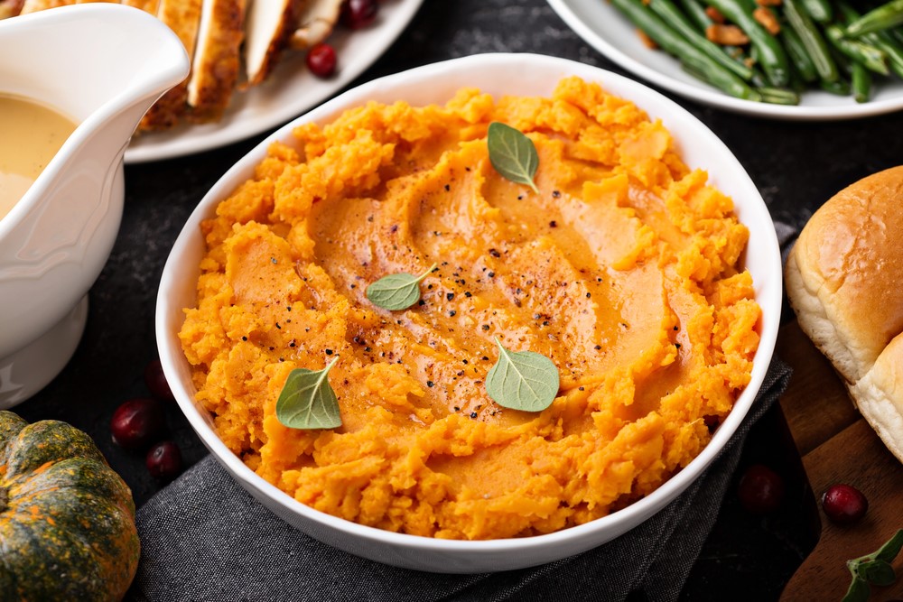 A large bowl of mashed sweet potatoes