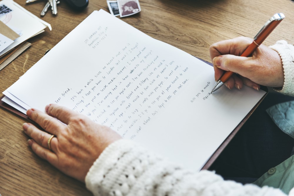 A senior woman writing a letter