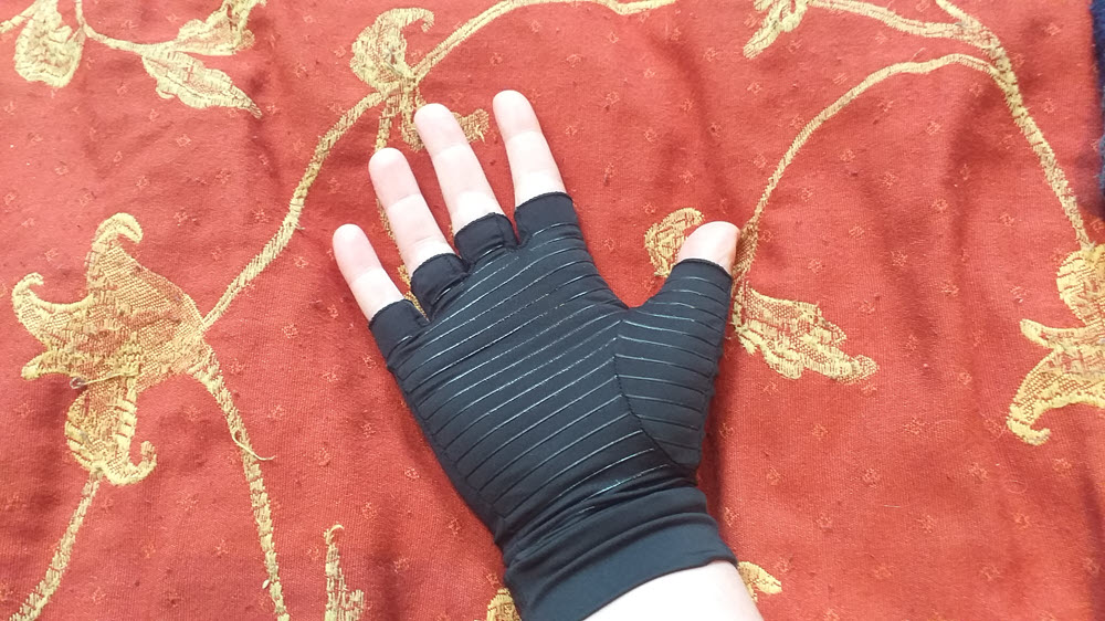 A black glove that could be used for Raynaud's or arthritis