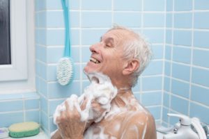 A senior man bathing with plenty of soap, highlighting the idea of hygiene for seniors