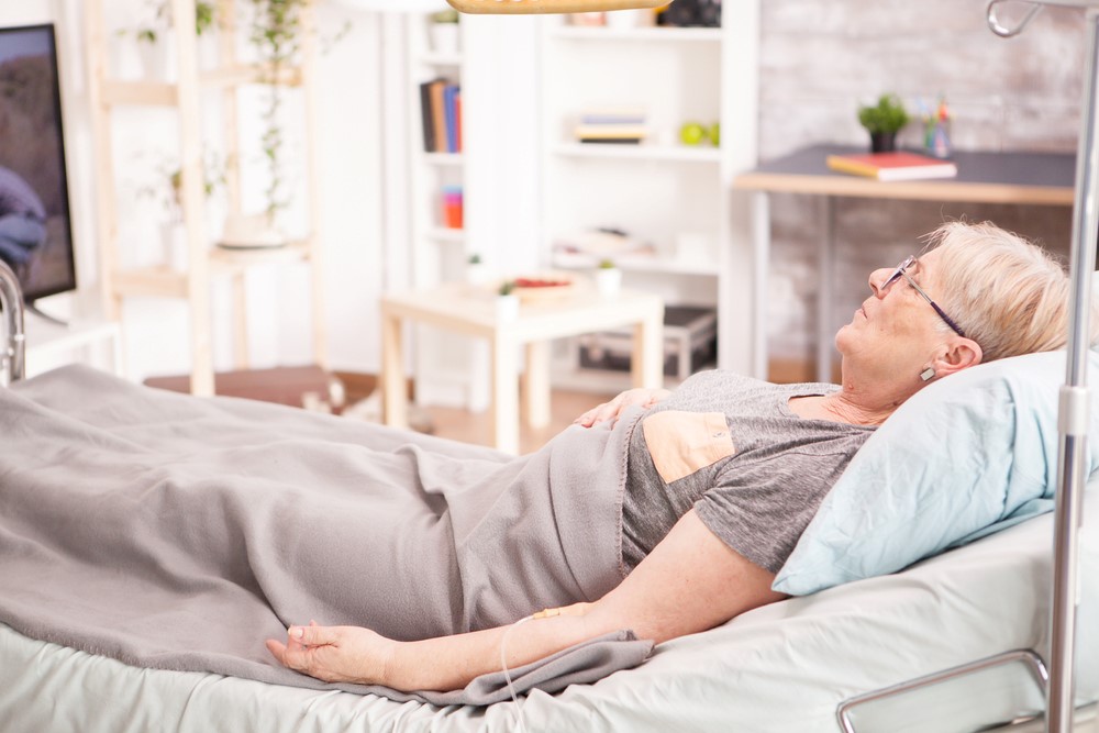 An older woman at home in a hospital bed