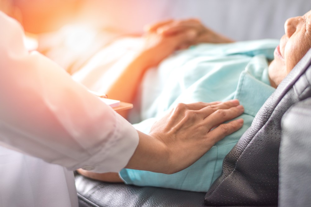 An older woman lying in a hospital bed