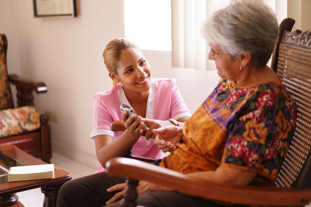 An older woman talking to a nurse