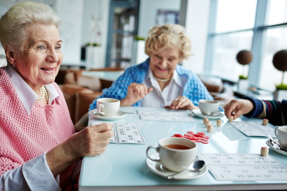 Women in assisted living, highlighting the benefits of bingo for seniors