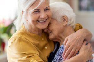 An older woman hugging her mother, highlighting the importance of good resources for caregivers