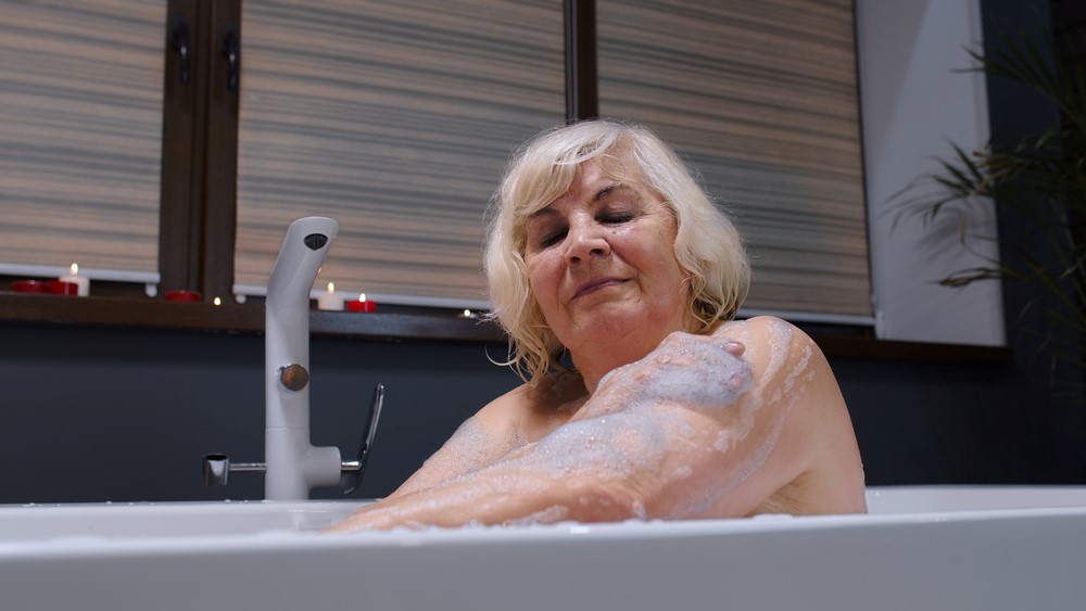 An older woman in a bath