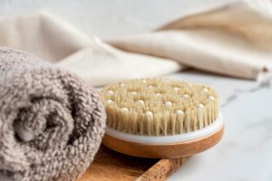 Supplies for a shower or a bath, including a long handled shower brush