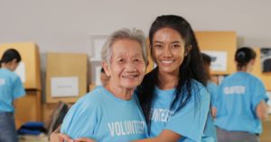 Two volunteers, one senior and one younger