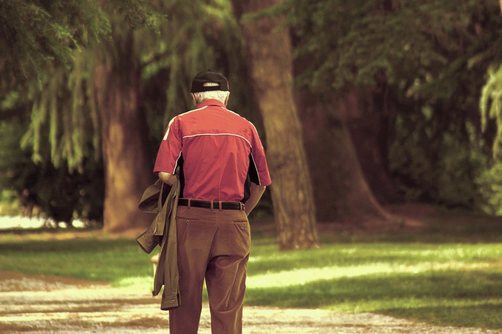 A senior wandering outside with dementia, highlighting the importance of GPS devices