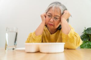 An aging woman who doesn't want to eat, highlighting the idea of tough love with elderly parents
