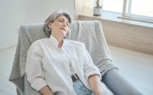 An older woman in an armchair, highlighting the link between home care services and senior health