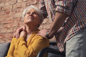 An older woman looking at a husband or caregiver, highlighting the question of whether you should include dementia patients in family holidays