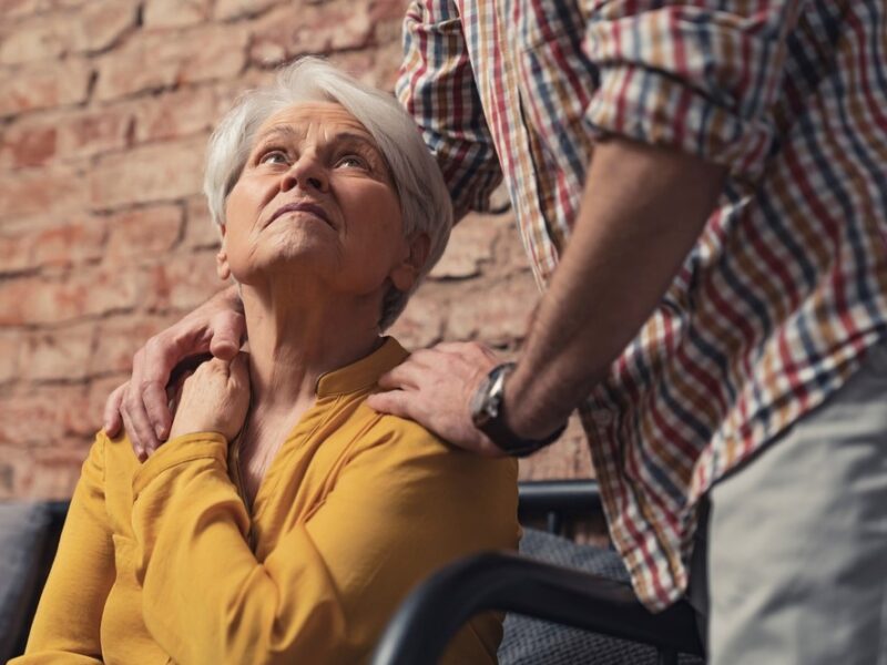 An older woman looking at a husband or caregiver, highlighting the question of whether you should include dementia patients in family holidays