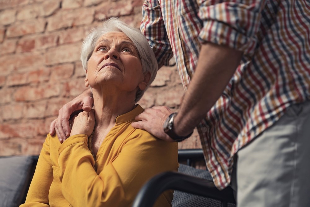 An older woman looking at a husband or caregiver, highlighting the question of whether you should include dementia patients in family celebrations