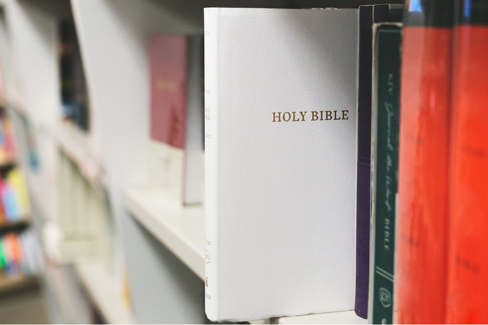 Bible on a book shelf, highlighting the source of caregiver burnout Bible verses