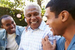 Two adult children with their aging father, highlighting the idea of getting siblings to help with aging parents