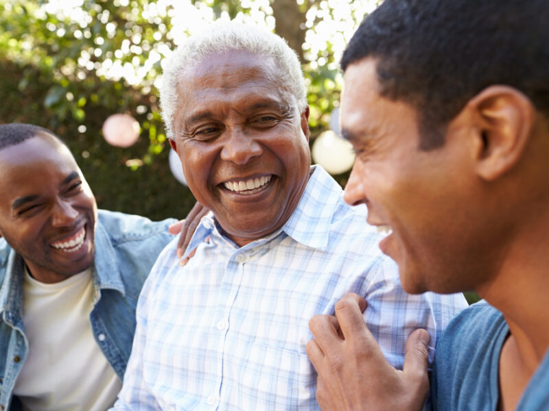 Two adult children with their aging father, highlighting the idea of getting siblings to help with aging parents