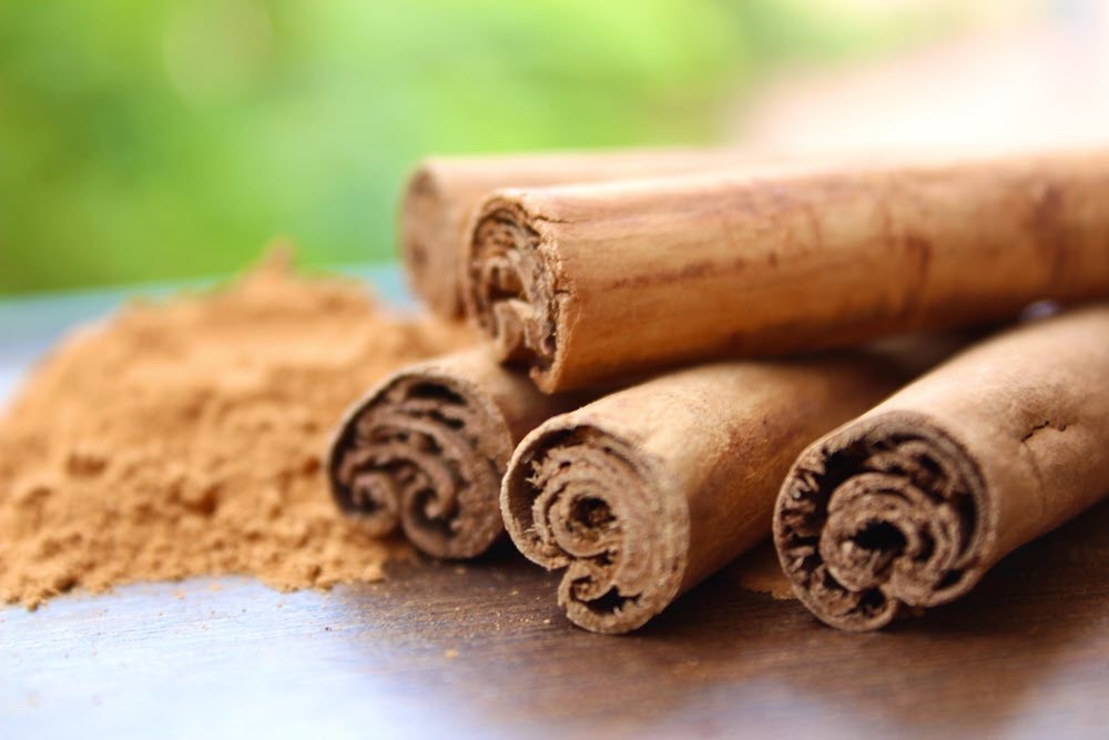 Ceylon cinnamon sticks, next to powdered cinnamon