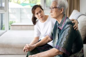 A young woman sitting with her aging mother, highlighting the question of how to set boundaries with a narcissistic parent