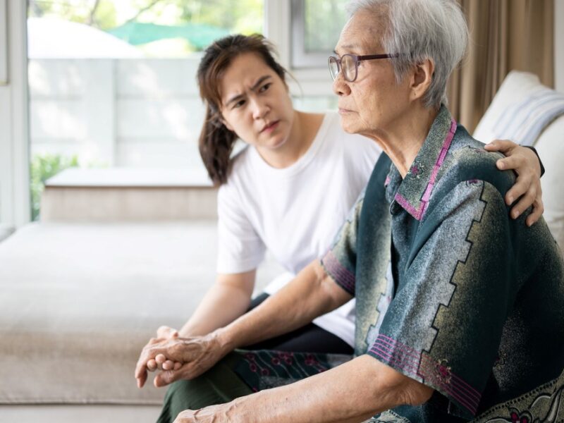 A young woman sitting with her aging mother, highlighting the question of how to set boundaries with a narcissistic parent