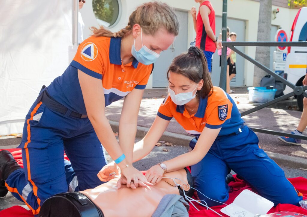 Two women participating in first aid training or basic life support training