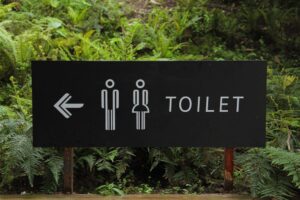 A sign for toilets, highlighting the idea of incontinence and potential solutions